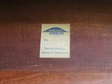 a label on the back of a chair that is made of wood