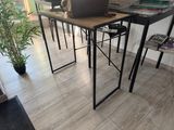 a laptop computer sitting on a desk in a room