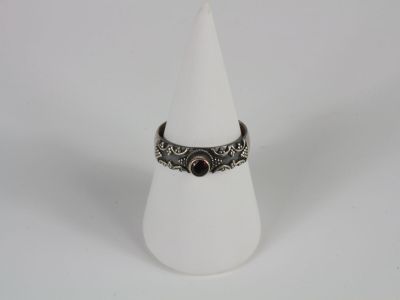 a close up of a ring on a cone on a white surface