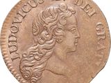 a close up of a coin with a woman ' s head on it