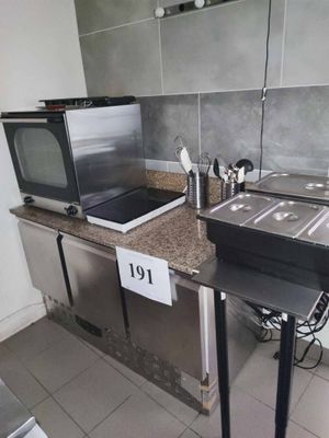 a small kitchen with a microwave, stove, sink and a microwave oven