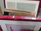 a box full of framed pictures on the floor