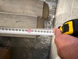 a man holding a measuring tape in his hand