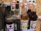 many bottles and containers of alcohol on the counter