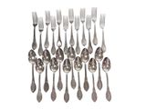 a group of silver spoons and forks on a white background