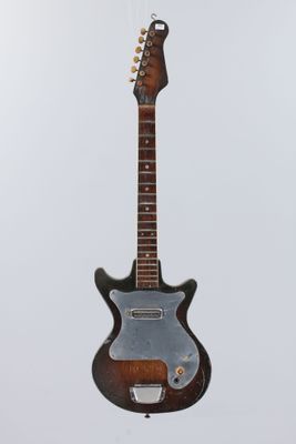 an electric guitar hanging from a string on a white background