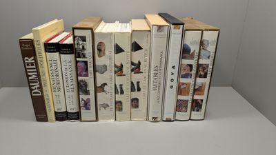 several books are stacked on top of each other on a table