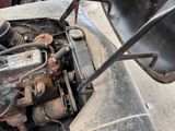 a close up of an old car engine with a rusted hood