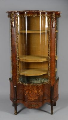 an antique display cabinet with a glass door and gold trimming