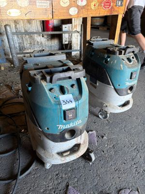two machines that are sitting on the floor in the room