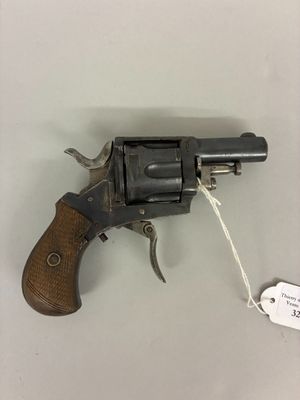 a close up of a revolver on a table with a price tag