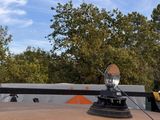 a car with a satellite dish on top of it