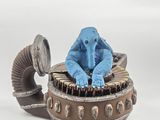 a blue elephant sitting on top of a teapot