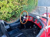 a red and black car with a steering wheel and dashboard