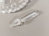 a clear glass vase and a clear glass pen on a table