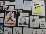 many different posters on the wall of this room