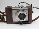 an old camera with a leather strap on a white background