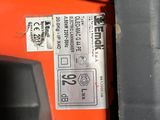 a close up of a red and black machine with a label on it