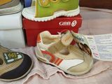 several pairs of children ' s shoes sitting on top of a table