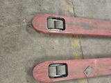 pair of skis sitting on the ground in a parking lot