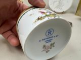 a person holding a coffee cup with a bird on it
