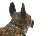 a figurine of a dog that is standing on a table