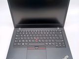 the laptop is open on a white surface with a black keyboard
