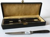a knife and a knife holder in a box