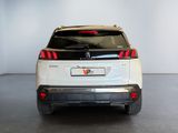 the rear end of a white suv parked in a garage