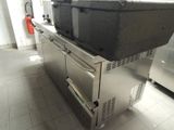 a large kitchen with a stove and a refrigerator