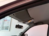 a view of a car ' s rear view mirror from inside the car