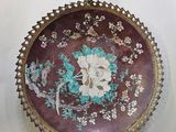 an image of a decorative plate hanging on a wall next to a hook
