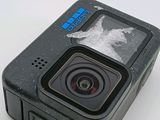 an action camera with a broken screen sitting on top of a table