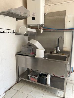 a kitchen with a sink and a refrigerator in it