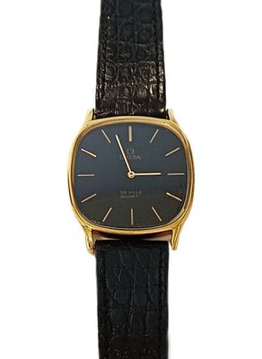 a close up of a watch on a white surface with a black strap