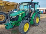 a tractor that is parked in the dirt