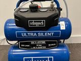 three air compressors stacked on top of each other on the floor