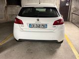 a small white car parked in a parking garage
