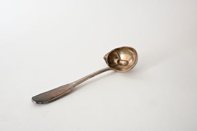 a spoon that is sitting on a white surface