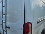a white van that has a ladder on the back of it