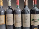 several bottles of wine are lined up in a row on a table