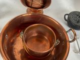 a copper plate with a cup and saucer on top of it