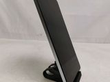 a close up of a tablet computer on a stand on a white surface