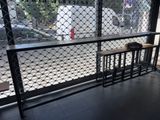 a view of the outside of a coffee shop through a fence