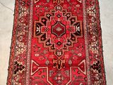 rug on the floor is red and black with a pattern on it