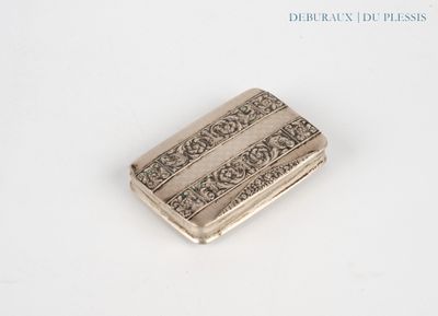 an antique silver cigarette case on a white surface