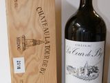 a bottle of wine sitting next to a wooden box