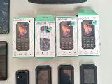 a lot of cell phones that are sitting on a table