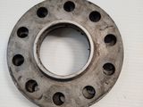 a metal ring with holes in it on a white surface