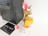a figurine of a woman sitting on top of a box